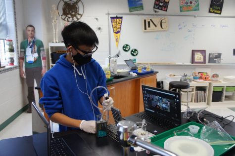 Brendan Wu (9), performs the enzyme lab in Ms. Keeley Lowerys AP Biology class on Sept. 23. In-person students were sent into breakout rooms and were responsible for the DVA students getting the information. I didnt really do it right and probably got a failing grade, but I had fun, Kyle Coburn (9) said. 
