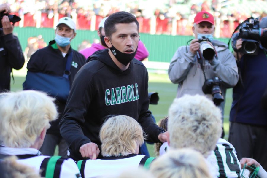 Coach Riley Dodge addresses his team after their win against the Trinity Trojans on Jan. 2. 