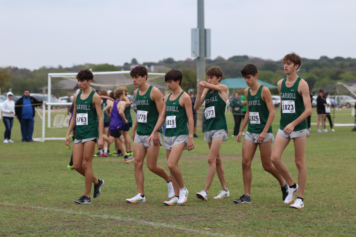 Cross country team members walk out toward their route. Photo by M. Brown