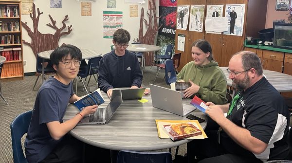 Literary Criticism team members meet with coach Steven Wallace to practice for their upcoming meet. Photo courtesy of Emily Maxwell. 