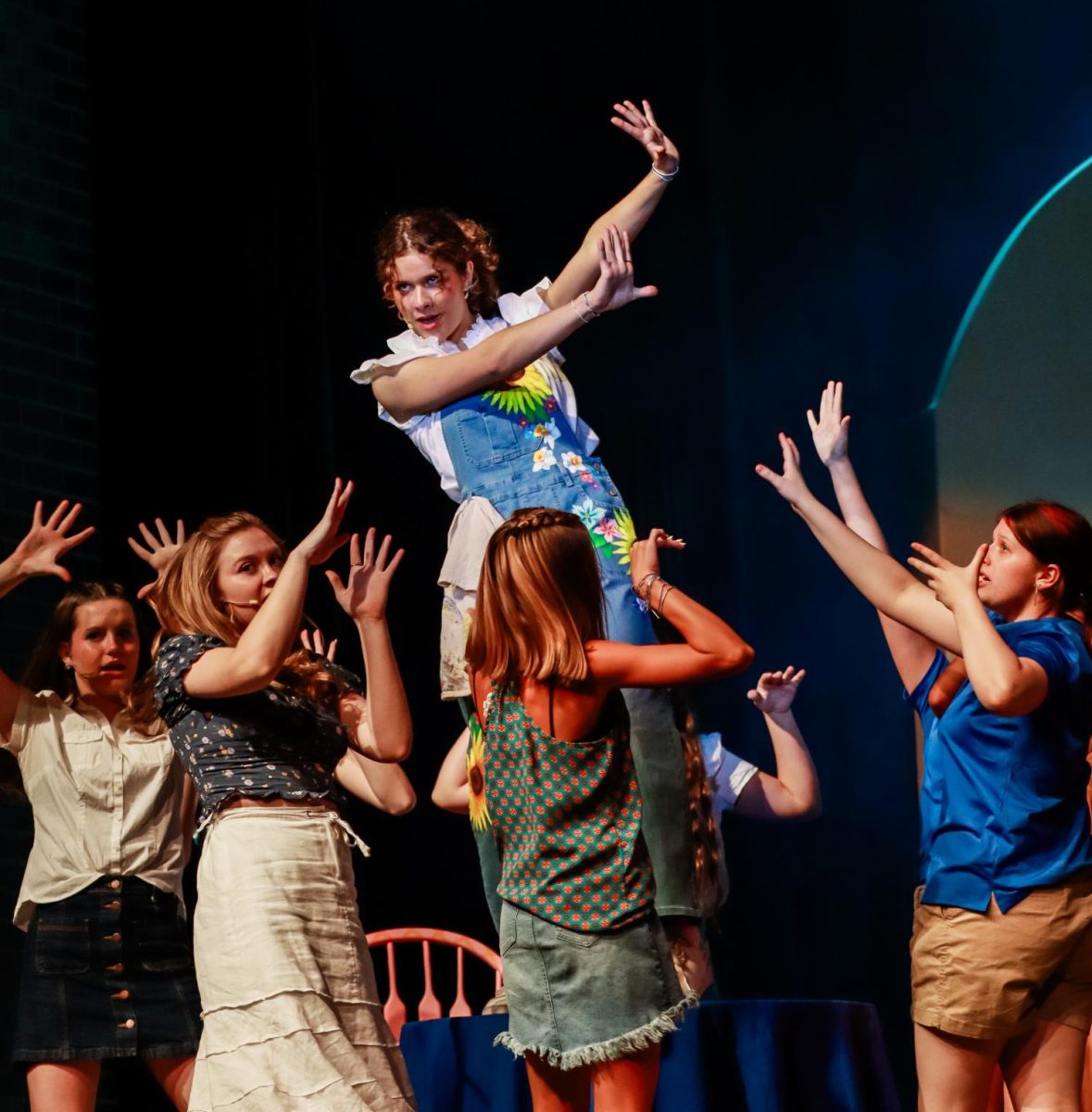 Carol Cortezze (12) wears hand-painted overalls during the performance of the song "Money, Money, Money" at the Sept. 15 dress rehearsal of the fall musical "Mamma Mia!". 