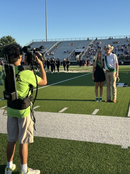 A CSMI intern films the 2024 homecoming king and queen during a pre-game ceremony last school year.